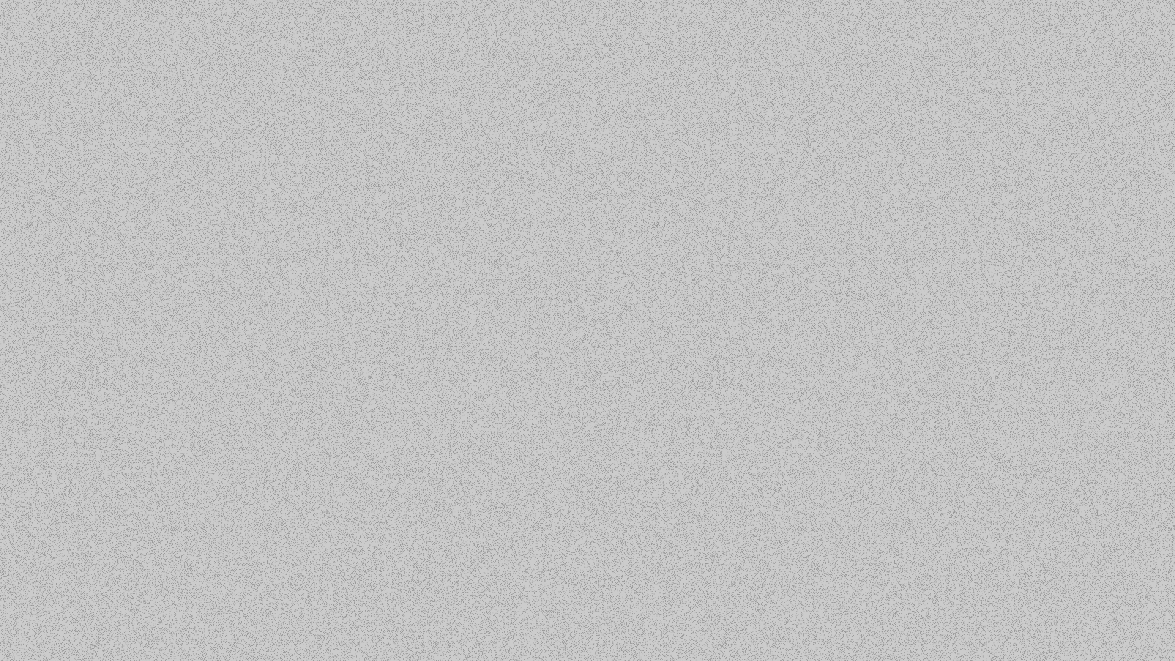 Two women sitting at a modern table talking with a city view behind them.