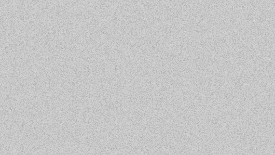 Two women sitting at a modern table talking with a city view behind them.